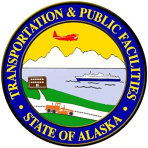 Seal of the State of Alaska featuring a plane, ferry, mountains, and a road, with the text